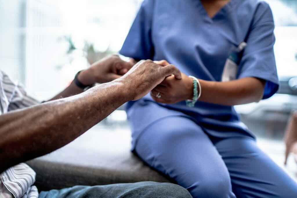 Evoke Health blog image with nurse and residents holding hands