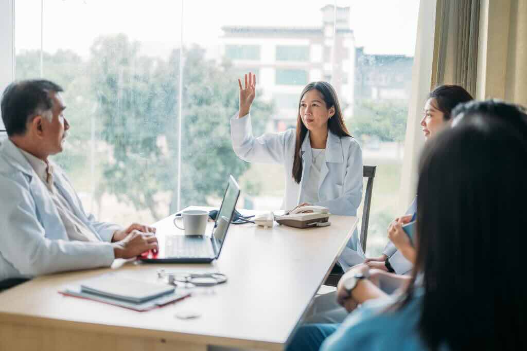 Evoke Health blog image with nurses and doctors in a meeting